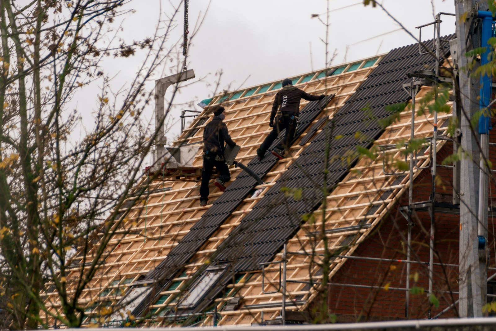 A roofer mid re-roof on a residential property