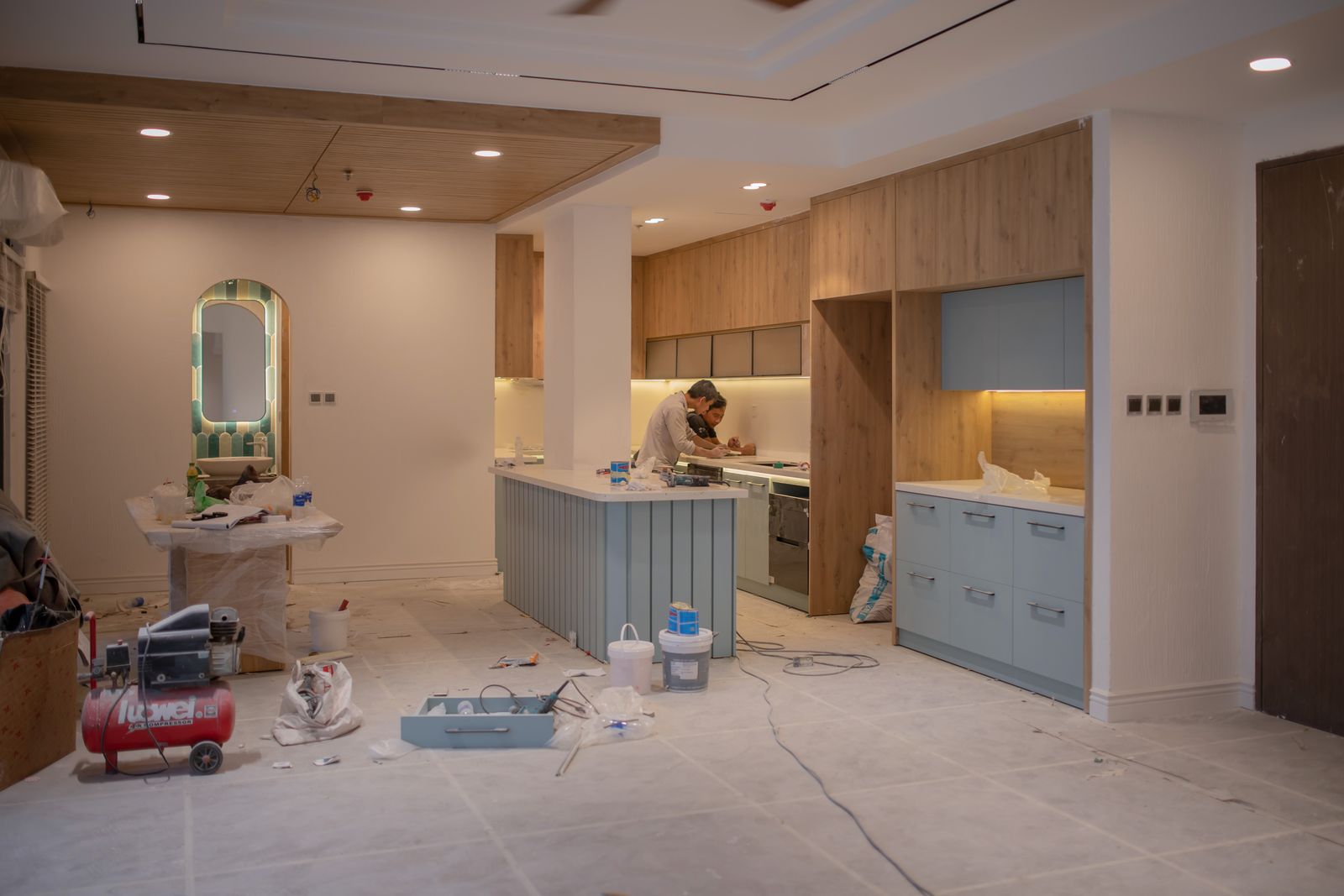 A kitchen fitter mid-installation in a new kitchen